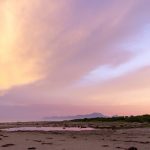 Stunning sunset view at Barra do Una beach, showcasing vibrant skies and serene coastline.