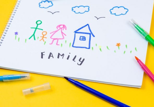 Home, love, family, still life concept. felt-tip pen lying on a paper with children's drawing family. Selective focus, copy space background