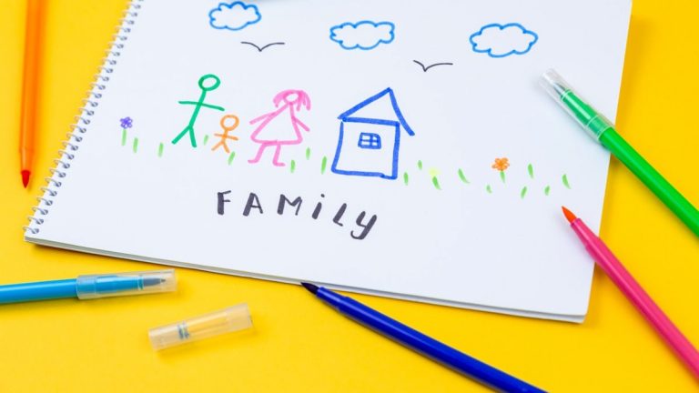 Home, love, family, still life concept. felt-tip pen lying on a paper with children's drawing family. Selective focus, copy space background