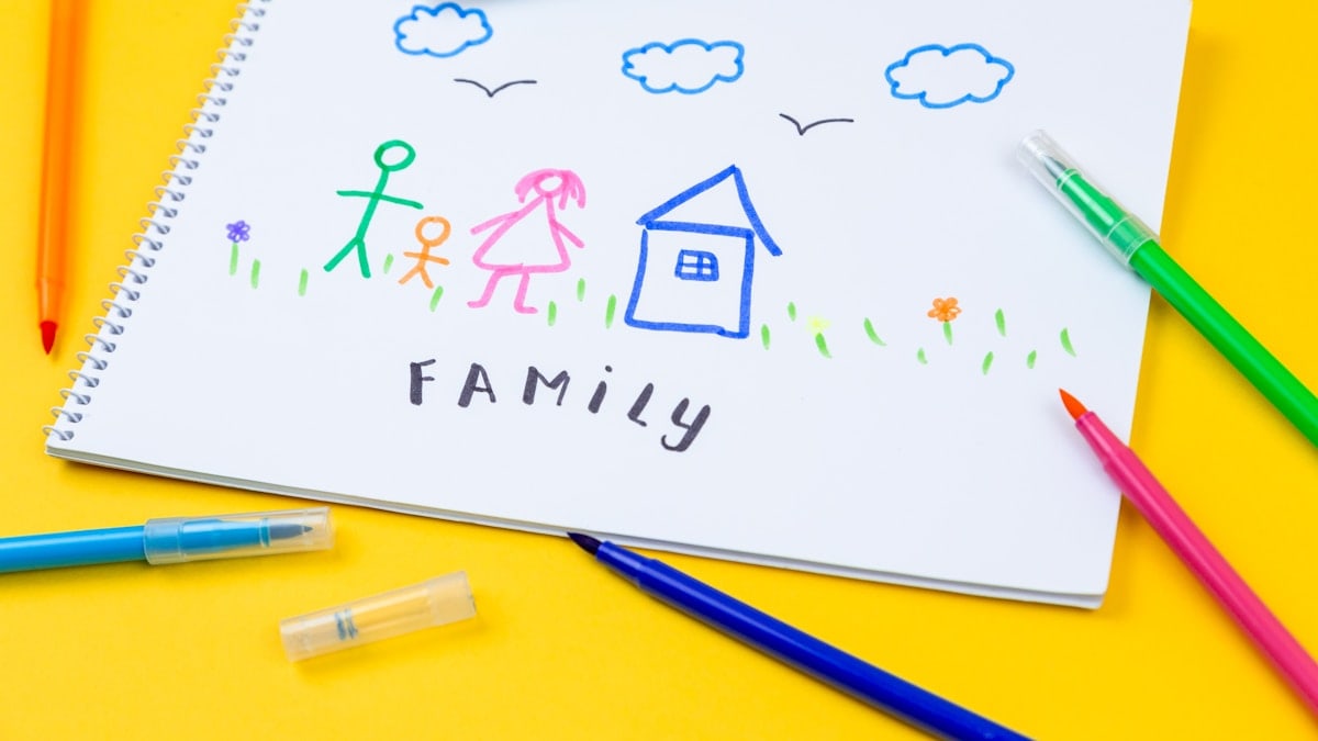 Home, love, family, still life concept. felt-tip pen lying on a paper with children's drawing family. Selective focus, copy space background